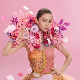 floral set design of wearable body flowers with pink artificial flowers for perfume advertising