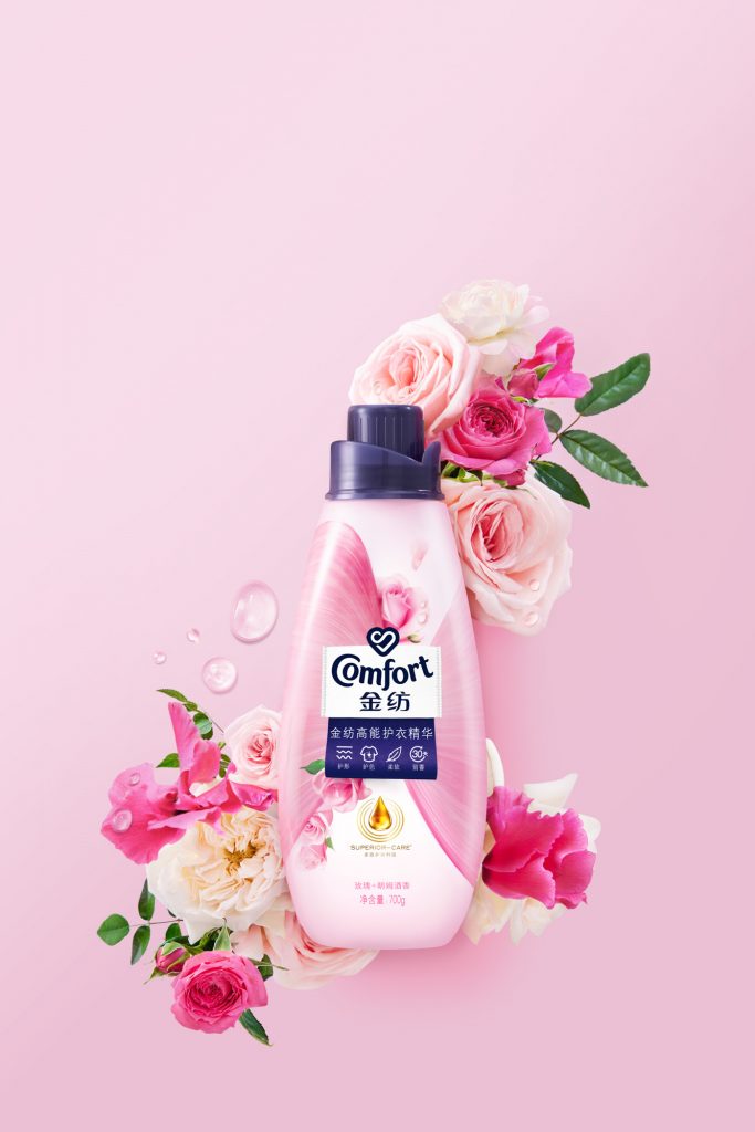 Conditioner pink bottle surrounded by pink and white roses