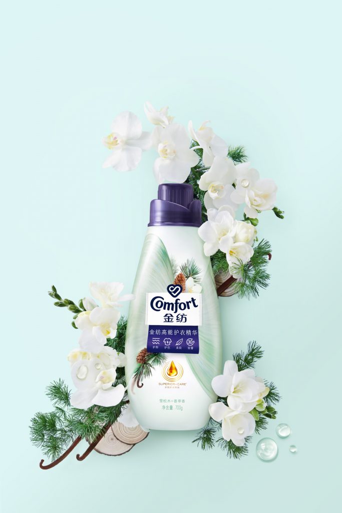 Conditioner green bottle surrounded by white and green flowers vanilla and orchids
