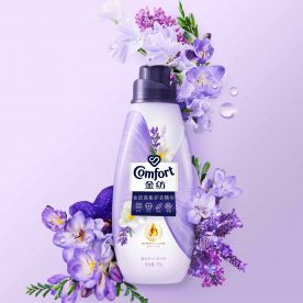 Conditioner purple bottle surrounded by purple flowers lavender freesia